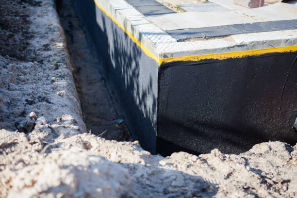 Professional Basement Waterproofing technician working in Russellville, AL